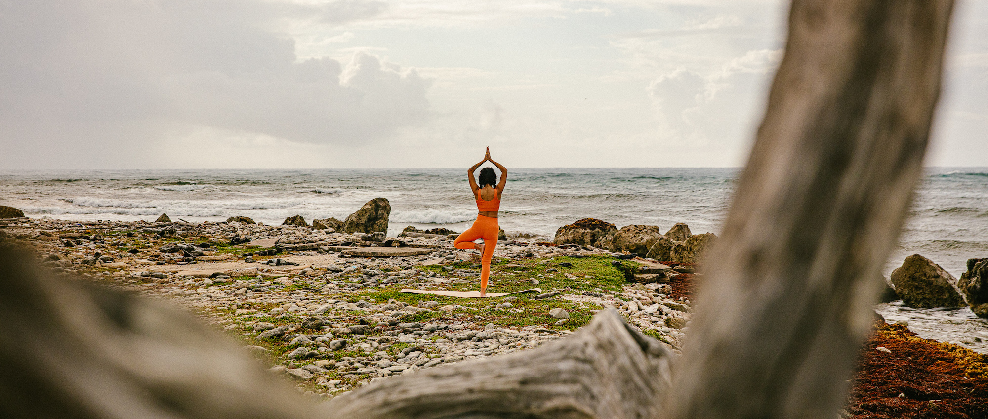 Woman doing yoga on beach