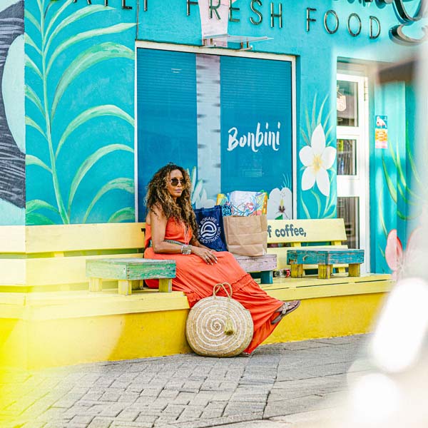 Woman sitting on yellow bench