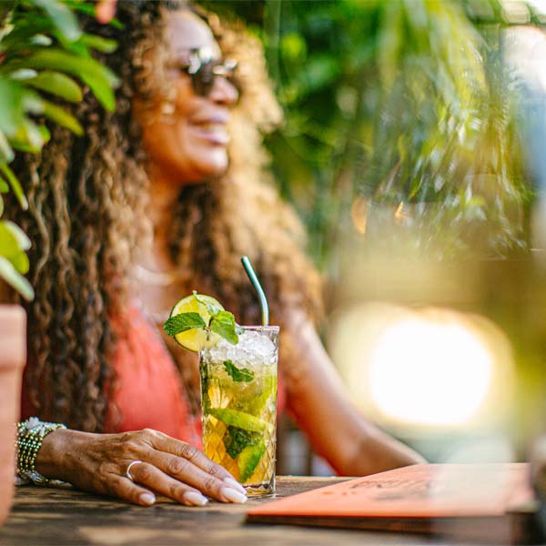 Woman sitting at table with cocktail