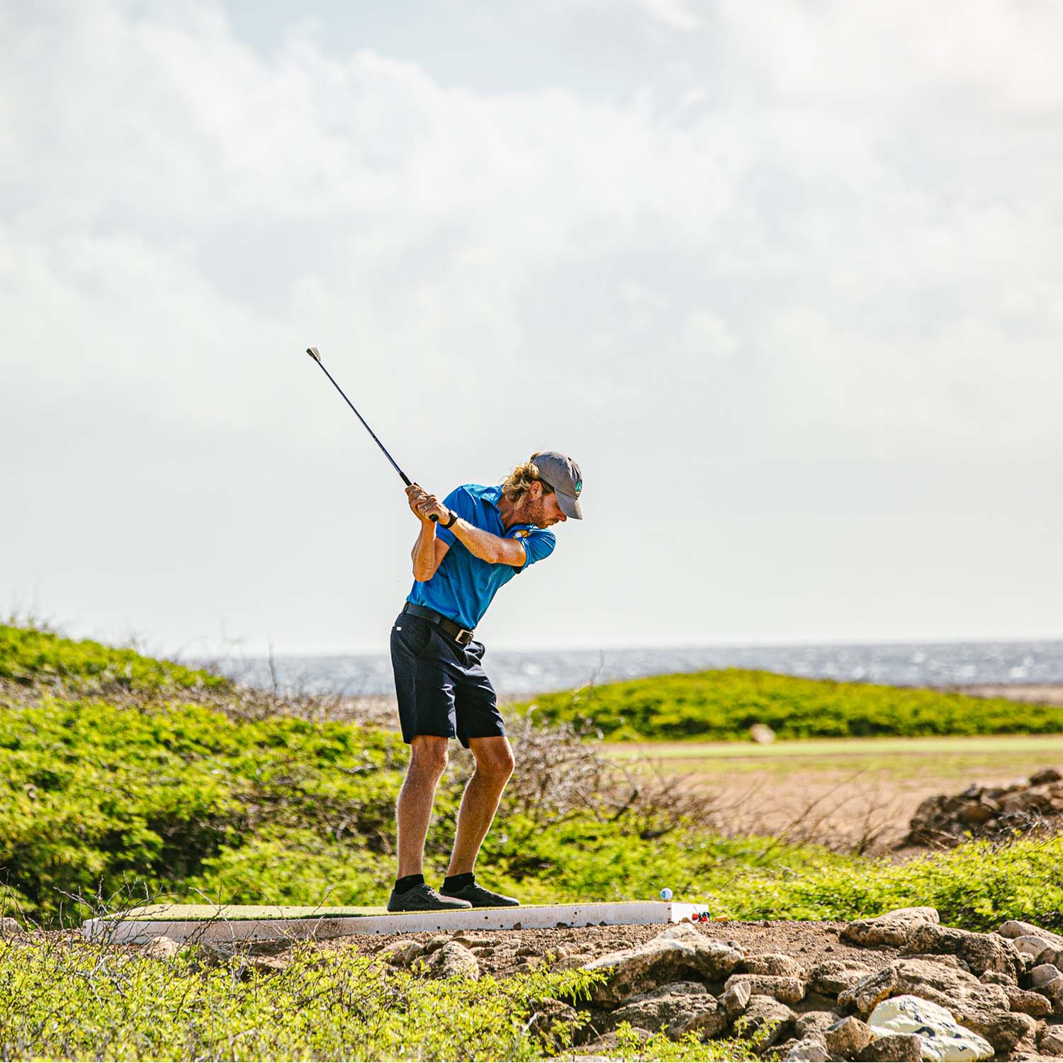Male swinging a golf club
