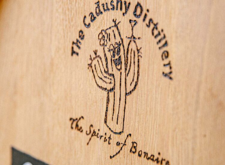 Close up shot of a wooden barrel with the company logo on it