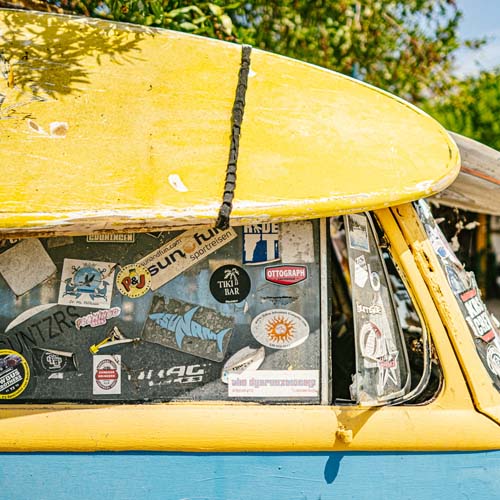 Van with surfboard on top