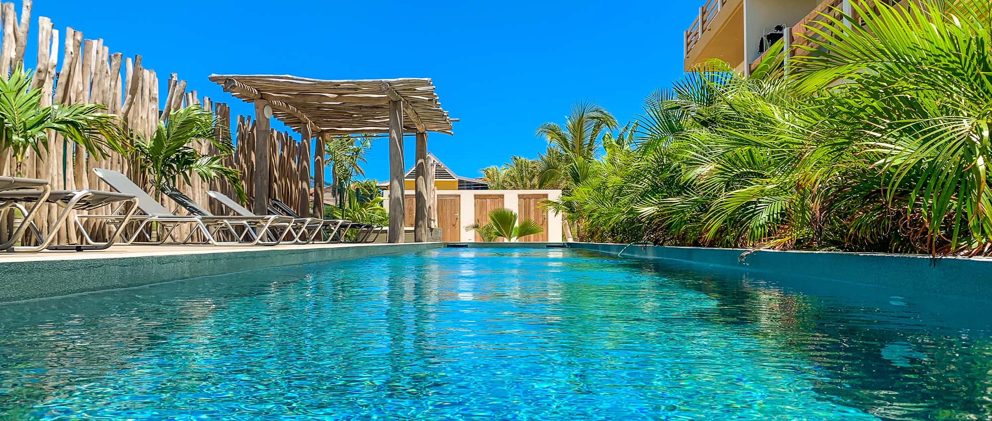 Outdoor pool area surrounded by lounge chairs