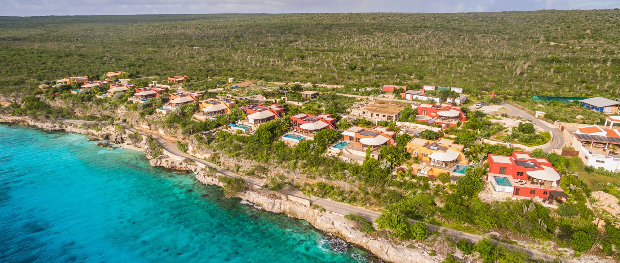 Aerial view of apartment property by the ocean
