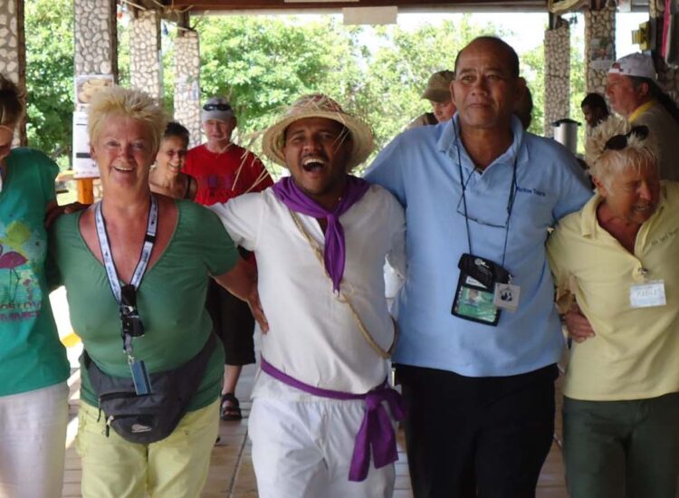 Tourists and tour guide lined up for a picture