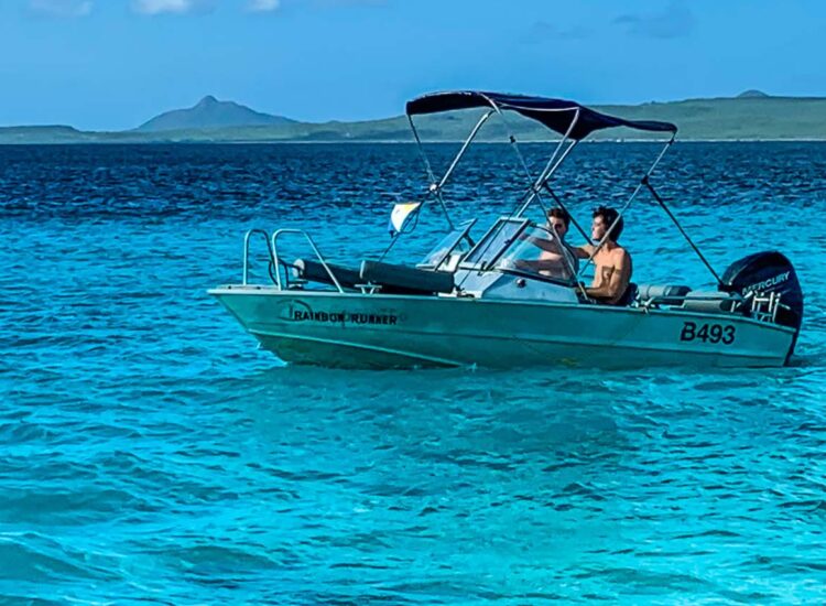 Two people aboard a boat in the ocean