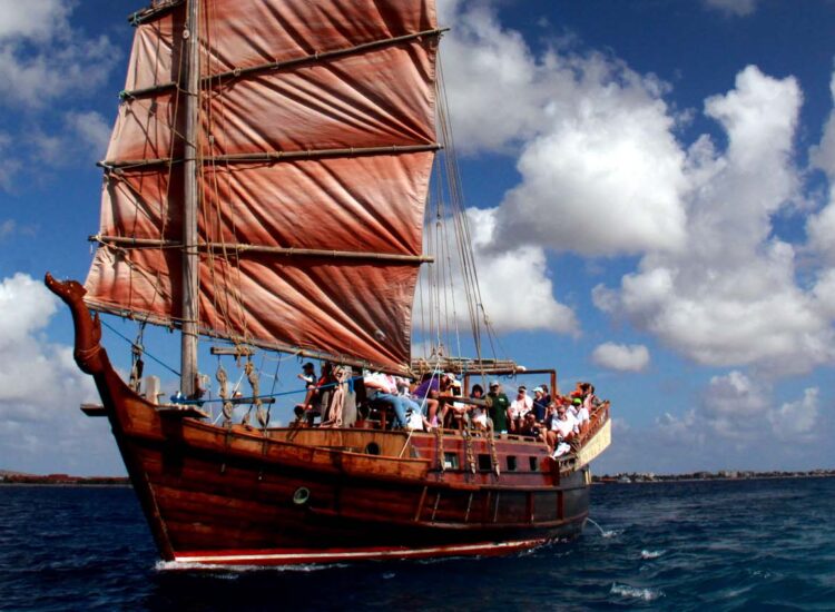 Many people aboard a large ship in the ocean