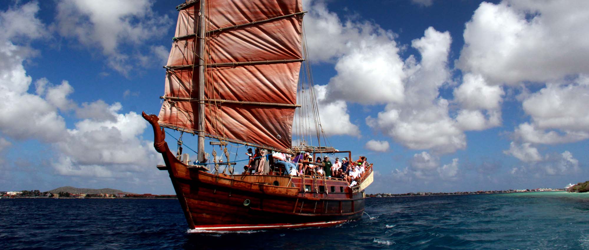 Many people aboard a large ship in the ocean